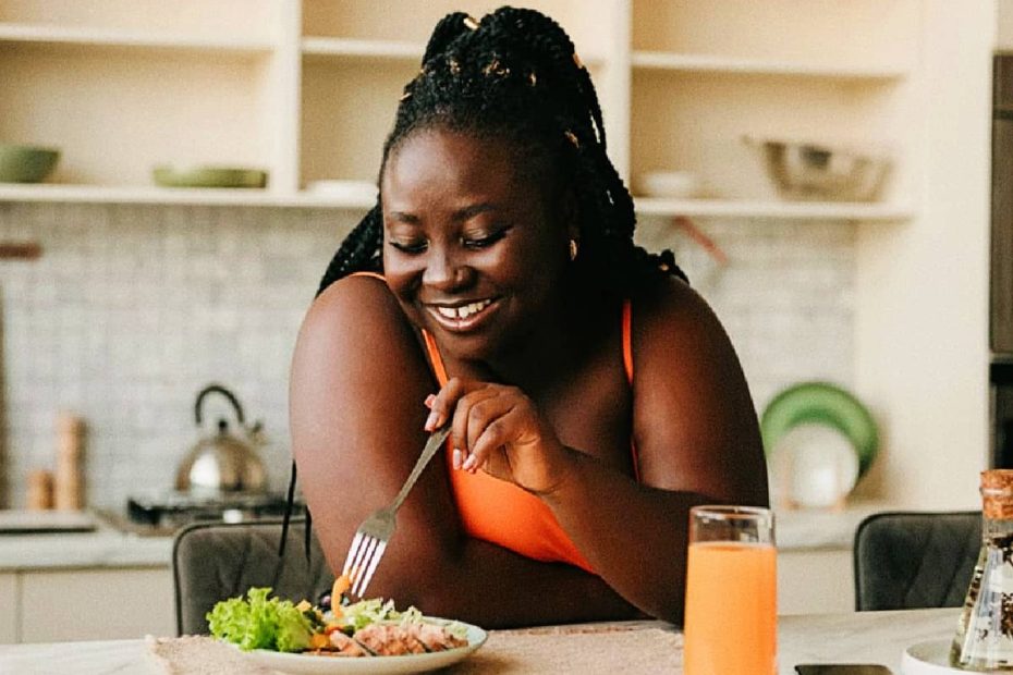 Four bowls of different colored nutrient and protein powders on a dark wooden surface.