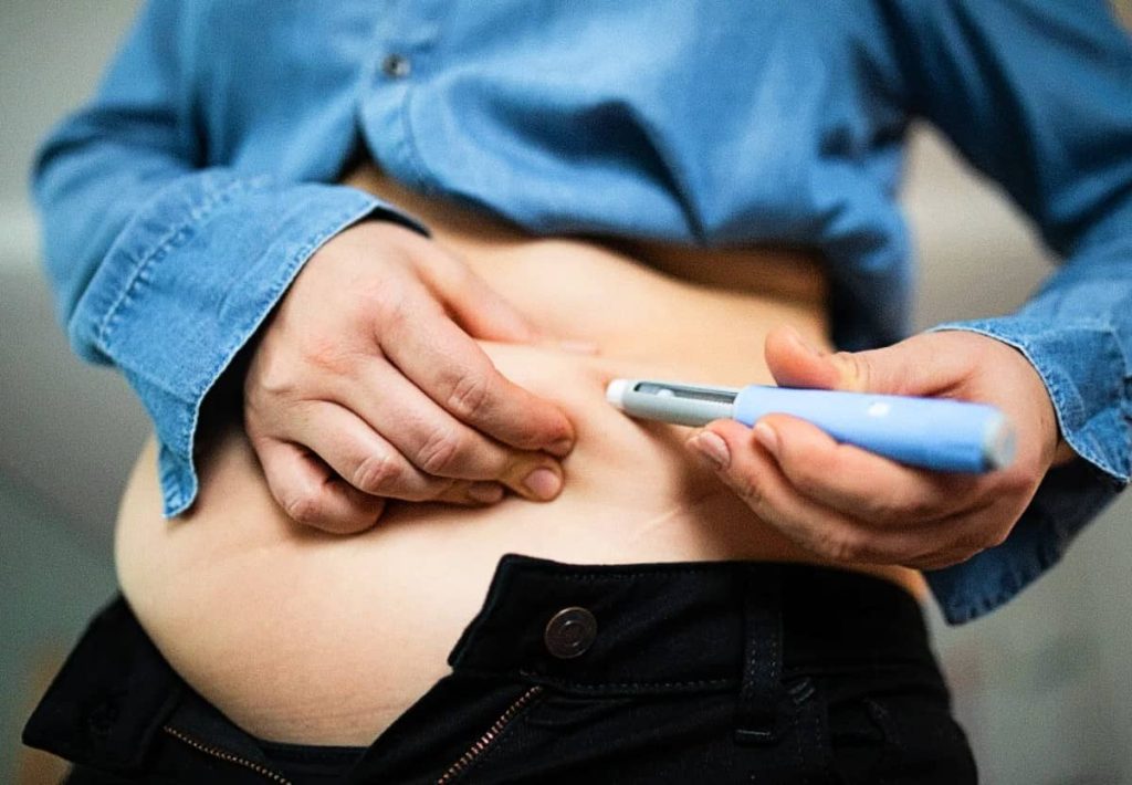 A white bowl filled with a high-protein, fluffy base like Greek yogurt or cottage cheese, decorated with dark patterns.