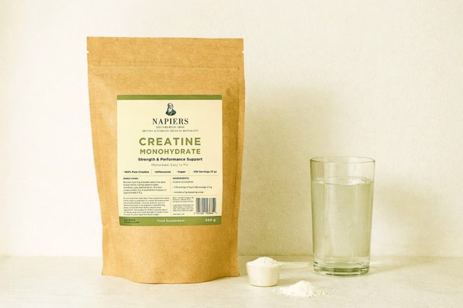 A bag of micronized creatine monohydrate next to a glass of water, illustrating a daily supplementation routine for metabolic health.